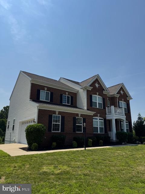 12701 Coventry Manor Way, Upper Marlboro, MD 20772 - view of front facade featuring an attached garage, brick siding, and a front yard