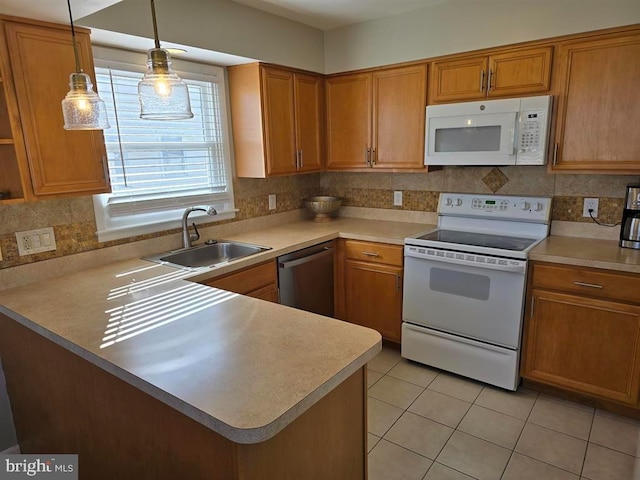 3 Lighthouse Cv, Brigantine, NJ 08203 - kitchen featuring white appliances, light countertops, a peninsula, light tile patterned floors, and brown cabinets