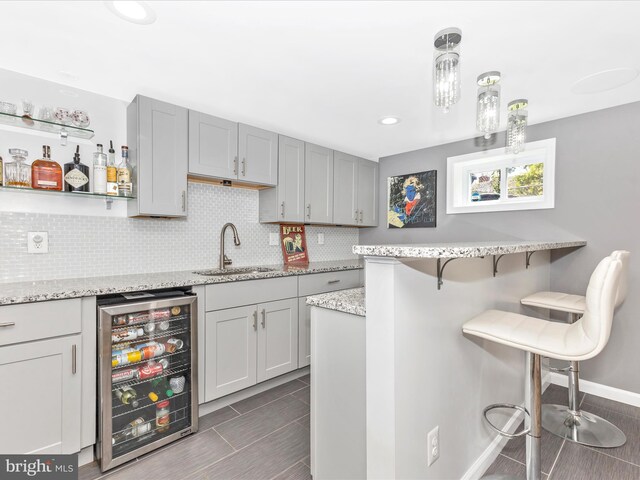 507 Kerwin Ct, Silver Spring, MD 20901 - kitchen featuring wine cooler, a kitchen breakfast bar, backsplash, light stone counters, and recessed lighting