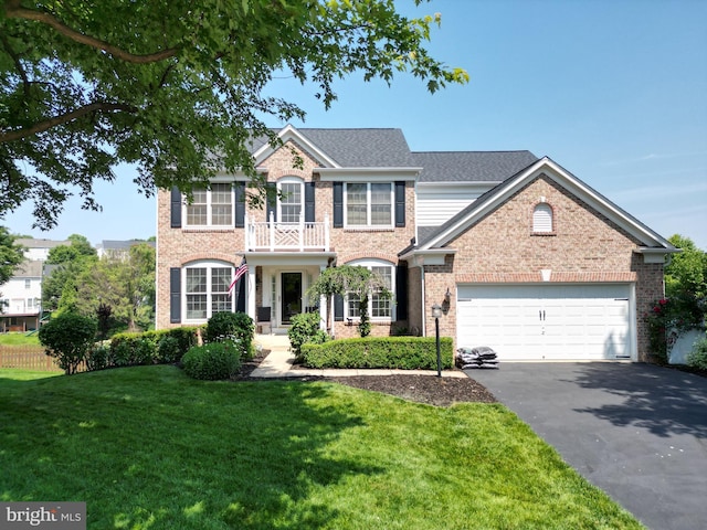 7540 Millpond Ct, Warrenton, VA 20187 - colonial house featuring asphalt driveway, a garage, a front lawn, and brick siding