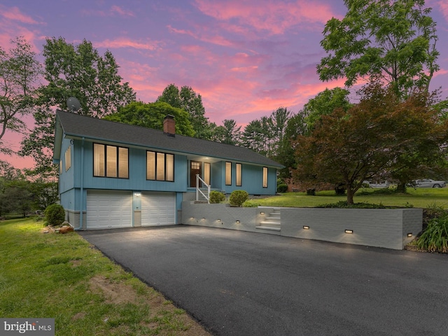 261 W Chestnut Hill Rd, Newark, DE 19713 - view of front of house with a chimney, driveway, an attached garage, and a yard
