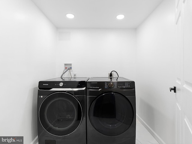 261 W Chestnut Hill Rd, Newark, DE 19713 - washroom featuring washer and dryer, marble look tiles, and recessed lighting