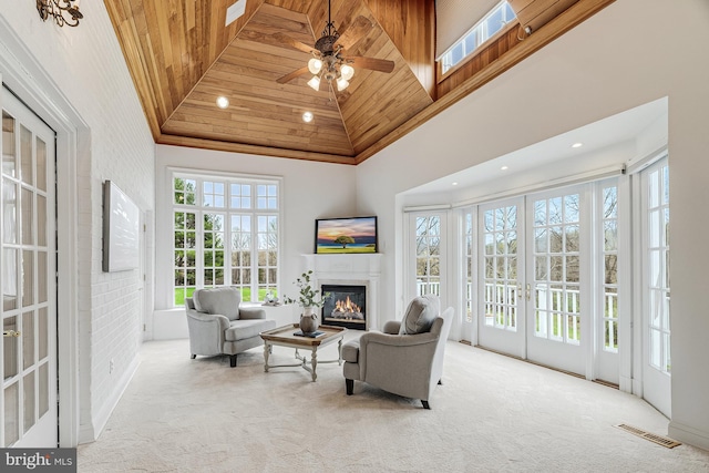 14000 Crossland Ln, Gaithersburg, MD 20878 - living room with high vaulted ceiling, carpet flooring, a glass covered fireplace, wood ceiling, and recessed lighting