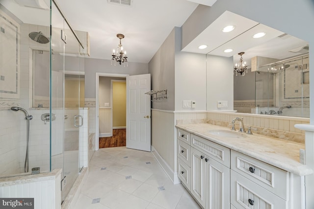 14000 Crossland Ln, Gaithersburg, MD 20878 - bathroom with a chandelier, a stall shower, vanity, tile patterned flooring, and a wainscoted wall