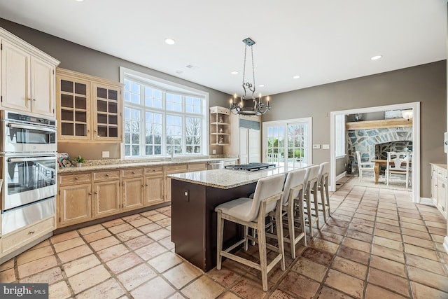 14000 Crossland Ln, Gaithersburg, MD 20878 - kitchen with a warming drawer, appliances with stainless steel finishes, a center island, a chandelier, and a breakfast bar area