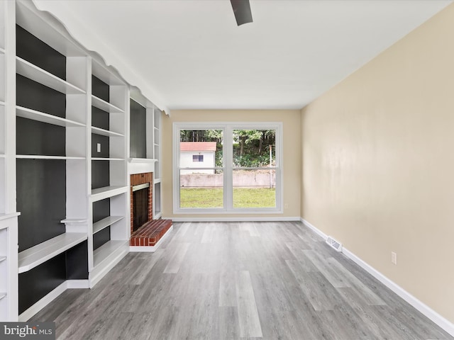 320 Valley View Ave, Keyser, WV 26726 - unfurnished living room with a brick fireplace and wood finished floors