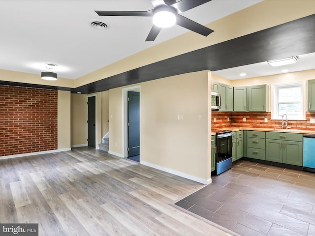 320 Valley View Ave, Keyser, WV 26726 - kitchen with green cabinetry, stainless steel appliances, a ceiling fan, light countertops, and brick wall