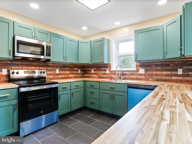 320 Valley View Ave, Keyser, WV 26726 - kitchen with appliances with stainless steel finishes, decorative backsplash, wooden counters, dark tile patterned floors, and recessed lighting