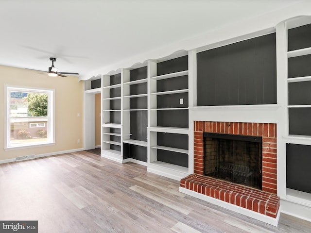 320 Valley View Ave, Keyser, WV 26726 - unfurnished living room featuring wood finished floors, a ceiling fan, and a brick fireplace
