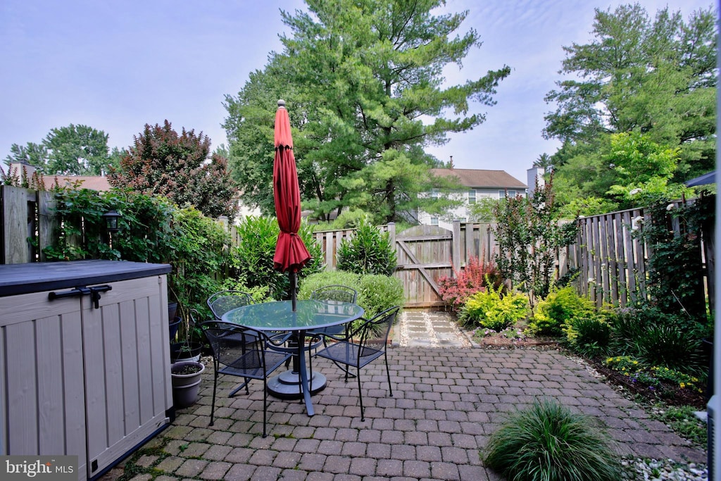 894 Smartts Ln NE, Leesburg, VA 20176 - fenced backyard with a patio area, outdoor dining area, and a gate