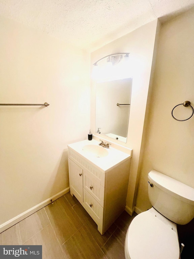 6011 State St, Cheverly, MD 20785 - bathroom with vanity, a textured ceiling, and wood finished floors
