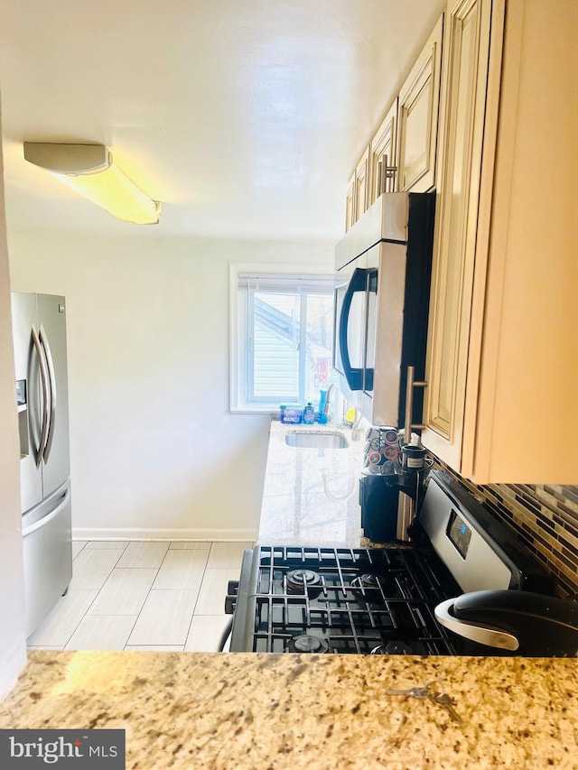 6011 State St, Cheverly, MD 20785 - kitchen featuring stainless steel appliances, backsplash, and cream cabinetry