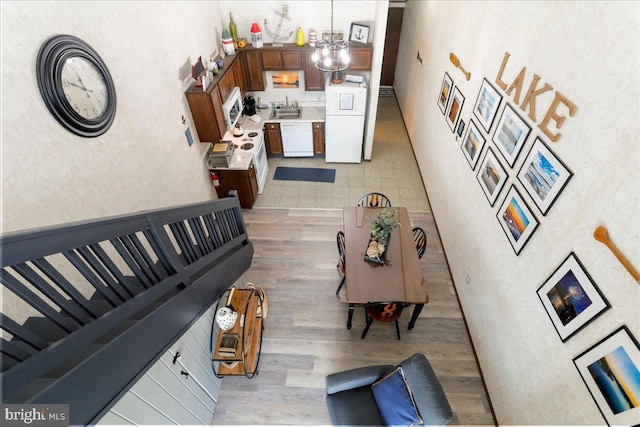 20160 Garrett Hwy Unit H708, Oakland, MD 21550 - living room featuring light wood-type flooring, a high ceiling, and a chandelier