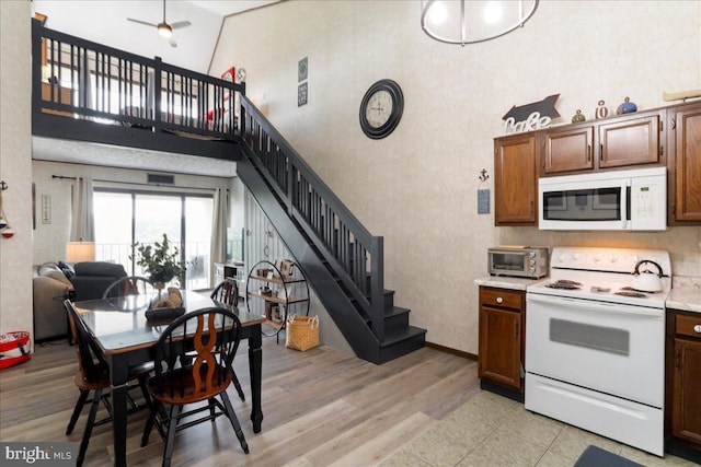20160 Garrett Hwy Unit H708, Oakland, MD 21550 - kitchen featuring white appliances, a high ceiling, light countertops, light wood-type flooring, and ceiling fan