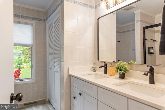 4 Bunkers Ct, Grasonville, MD 21638 - bathroom featuring tile walls, crown molding, double vanity, and a closet