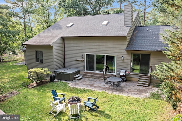 4 Bunkers Ct, Grasonville, MD 21638 - rear view of house with a patio, a hot tub, entry steps, roof with shingles, and a fire pit