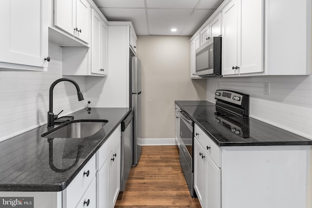 1557 Fairview Ave, Langhorne, PA 19047 - kitchen with stainless steel appliances, white cabinetry, recessed lighting, dark wood-type flooring, and dark stone countertops