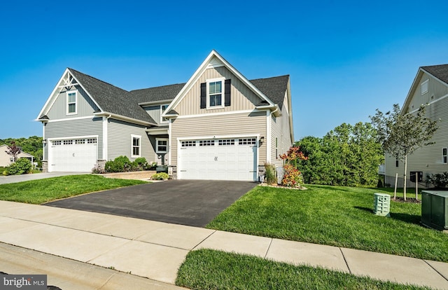 621 Thomas Penn Dr, West Grove, PA 19390 - craftsman-style house with board and batten siding, an attached garage, asphalt driveway, and stone siding
