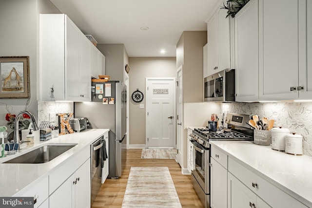 621 Thomas Penn Dr, West Grove, PA 19390 - kitchen with stainless steel appliances, backsplash, light wood-type flooring, light countertops, and recessed lighting