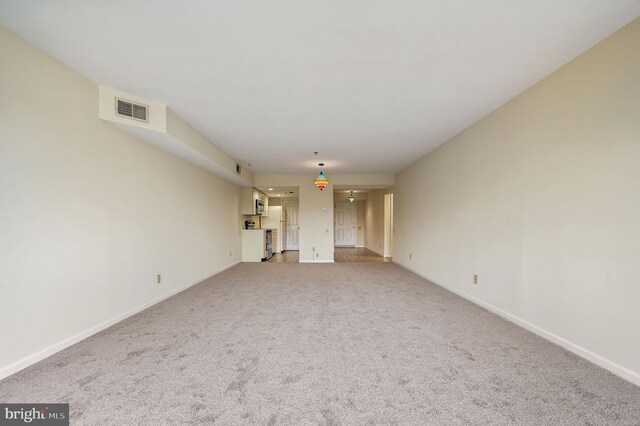 1967 Superfine Ln # 87, Wilmington, DE 19802 - unfurnished living room featuring baseboards and light carpet