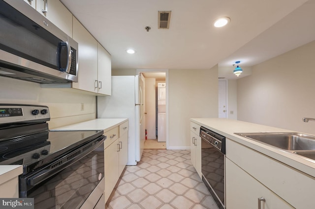 1967 Superfine Ln # 87, Wilmington, DE 19802 - kitchen with electric range, stainless steel microwave, black dishwasher, light floors, and light countertops