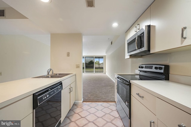 1967 Superfine Ln # 87, Wilmington, DE 19802 - kitchen with stainless steel appliances, light countertops, light carpet, recessed lighting, and open floor plan