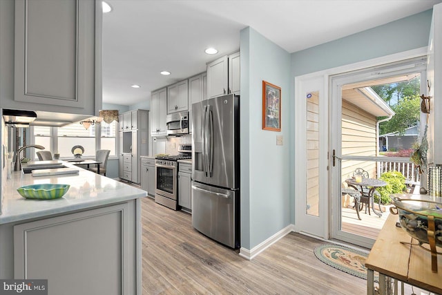 352 Ocean, Ocean Pines, MD 21811 - kitchen featuring stainless steel appliances, gray cabinets, light wood-type flooring, recessed lighting, and tasteful backsplash