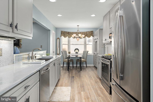 352 Ocean, Ocean Pines, MD 21811 - kitchen featuring appliances with stainless steel finishes, a chandelier, light wood-style flooring, recessed lighting, and decorative light fixtures