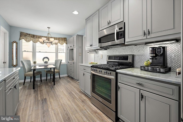 352 Ocean, Ocean Pines, MD 21811 - kitchen featuring appliances with stainless steel finishes, gray cabinets, a chandelier, tasteful backsplash, and recessed lighting