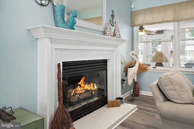 352 Ocean, Ocean Pines, MD 21811 - detailed view of a glass covered fireplace, wood finished floors, and a ceiling fan