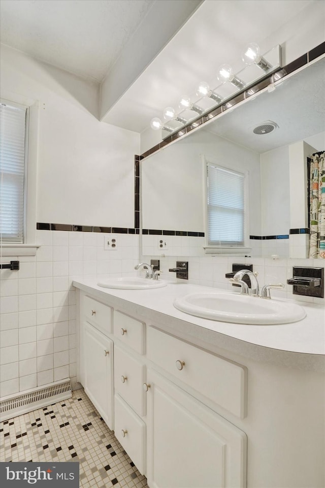 716 Hillcrest Rd, York, PA 17403 - bathroom with tile walls, double vanity, tile patterned flooring, and a wainscoted wall