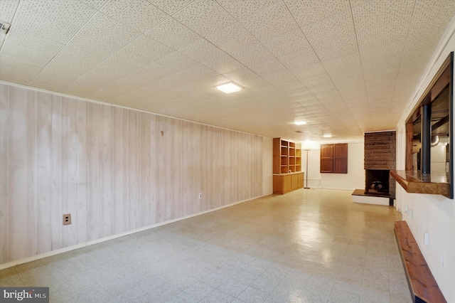 716 Hillcrest Rd, York, PA 17403 - unfurnished living room with a fireplace, light flooring, and wooden walls