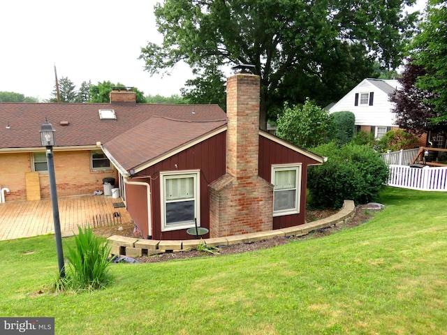716 Hillcrest Rd, York, PA 17403 - back of house featuring a chimney, a deck, roof with shingles, and board and batten siding