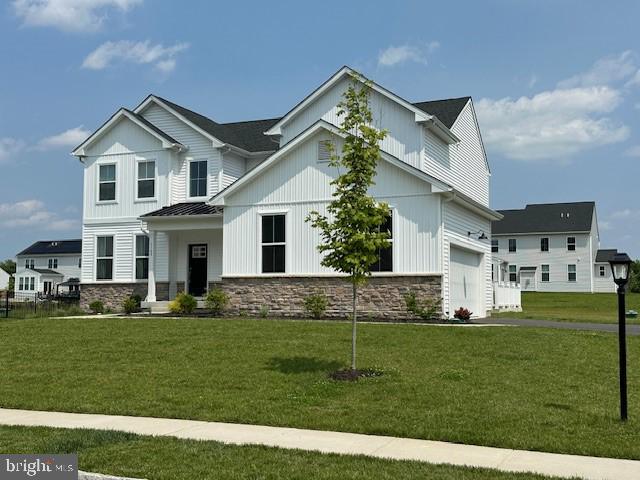 1142 Mariwill Dr, Quakertown, PA 18951 - view of front facade featuring stone siding, an attached garage, and a front yard