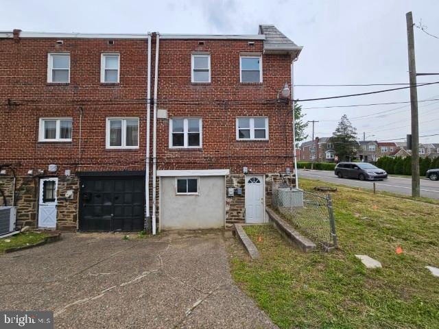 8400 Fayette St, Philadelphia, PA 19150 - back of property with an attached garage, concrete driveway, and brick siding