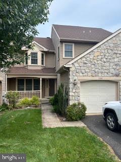 1160 Kipling Ct, Lansdale, PA 19446 - view of front of property with driveway, stone siding, a porch, a front yard, and a garage