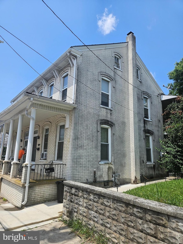 123 E Water St, Middletown, PA 17057 - view of side of home with a porch, brick siding, and a chimney