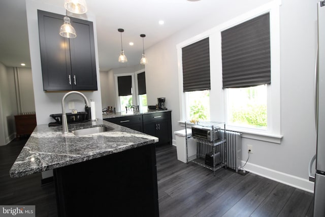 126 E Third St, Lansdale, PA 19446 - kitchen featuring radiator, dark wood-type flooring, dark stone countertops, a peninsula, and decorative light fixtures