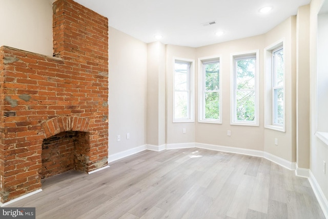 4136 Pennsgrove St, Philadelphia, PA 19104 - unfurnished living room featuring light wood finished floors and a brick fireplace