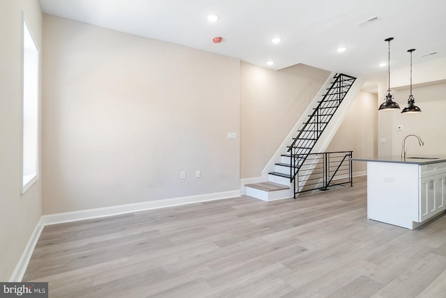 4136 Pennsgrove St, Philadelphia, PA 19104 - unfurnished living room with light wood-style floors, stairway, recessed lighting, and plenty of natural light