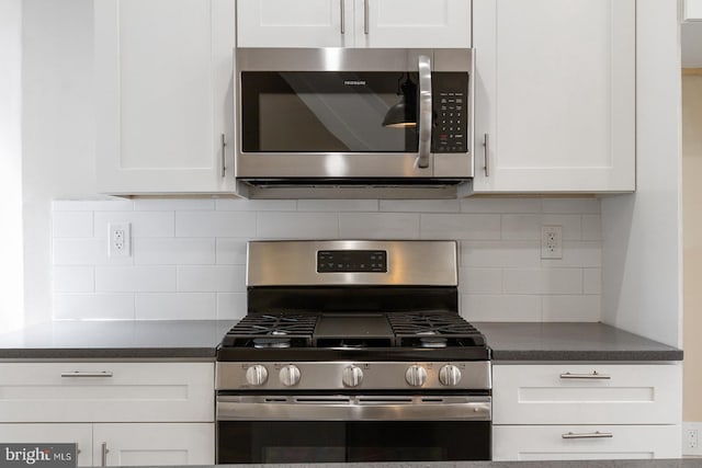 4136 Pennsgrove St, Philadelphia, PA 19104 - kitchen featuring appliances with stainless steel finishes, white cabinetry, dark countertops, and decorative backsplash