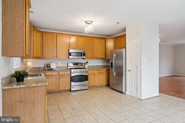 14608 Turara Ct, Haymarket, VA 20169 - kitchen with stainless steel appliances, light tile patterned flooring, light stone counters, and crown molding
