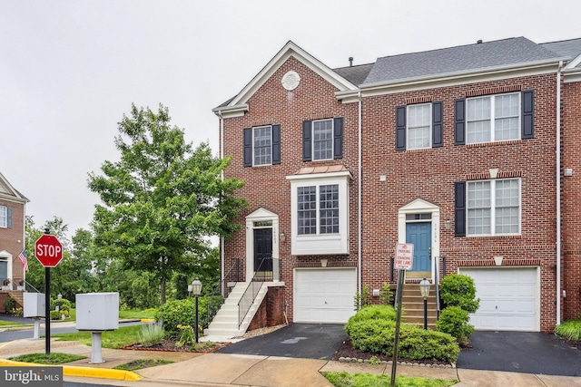 14608 Turara Ct, Haymarket, VA 20169 - view of front facade with asphalt driveway, an attached garage, and brick siding