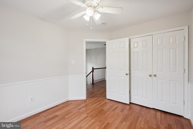 14608 Turara Ct, Haymarket, VA 20169 - unfurnished bedroom featuring wainscoting, light wood-type flooring, a closet, and a ceiling fan