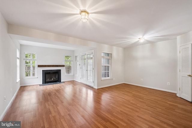 14608 Turara Ct, Haymarket, VA 20169 - unfurnished living room featuring wood finished floors and a fireplace with flush hearth