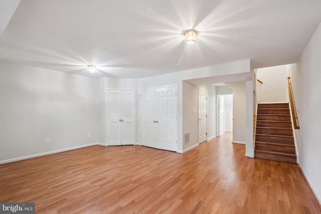 14608 Turara Ct, Haymarket, VA 20169 - unfurnished living room with light wood finished floors and stairs