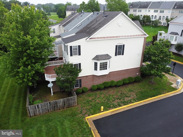 14608 Turara Ct, Haymarket, VA 20169 - view of side of property featuring brick siding, a shingled roof, a standing seam roof, a metal roof, and a yard