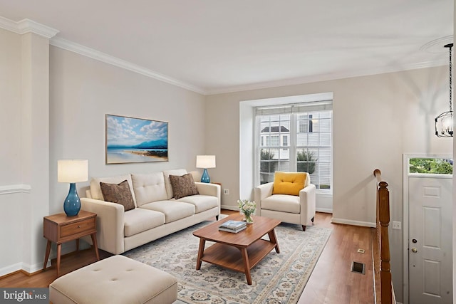 14608 Turara Ct, Haymarket, VA 20169 - living area with ornamental molding, light wood-style flooring, and a chandelier