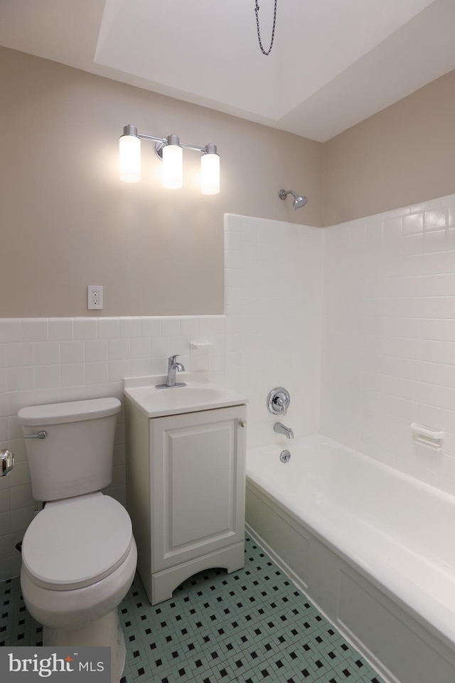 607 Briarcliff Rd, Upper Darby, PA 19082 - bathroom featuring  shower combination, a wainscoted wall, tile walls, vanity, and tile patterned floors