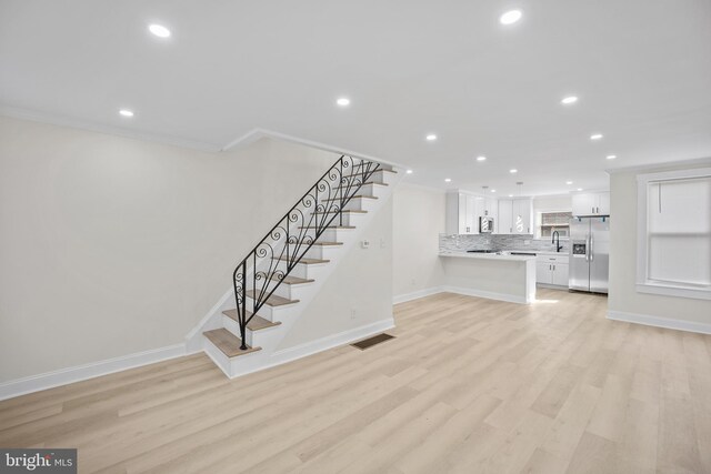 7726 Temple Rd, Philadelphia, PA 19150 - unfurnished living room with recessed lighting, crown molding, stairway, and light wood-style floors